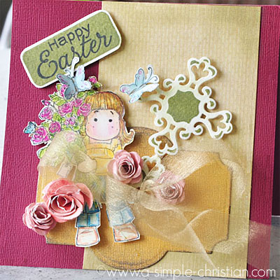A happy easter card handmade using a spellbinder cross die and sweet magnolia stamp with rolled paper roses.